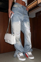 Pantalon large en jean délavé femme avec imprimé colombe et effet usé