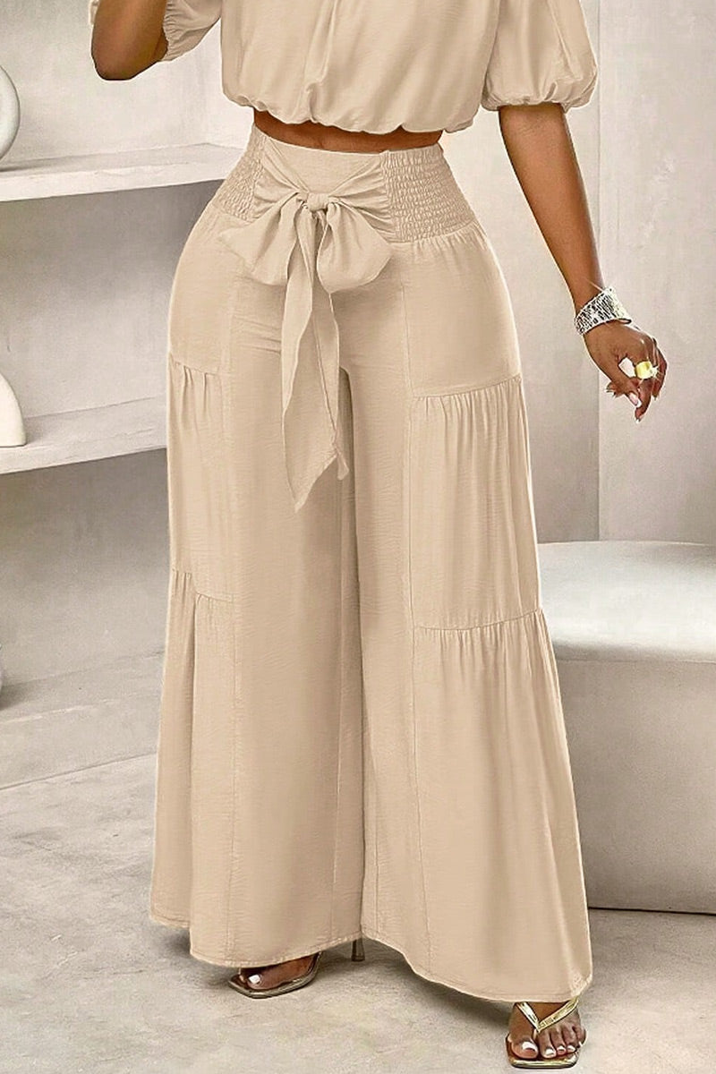 Chemisier court ample élastique à épaules dénudées et manches bouffantes ou pantalon large fluide étagé à taille haute smockée et noué sur le devant