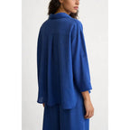 Completo due pezzi: maglia ampia a camicia, pantaloni ampi con elastico in vita.
